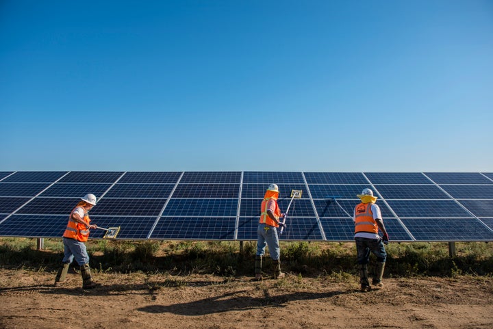 <p>Worker's clean solar panels for maximum efficiency at the power solar facility in Lancaster, California.</p>