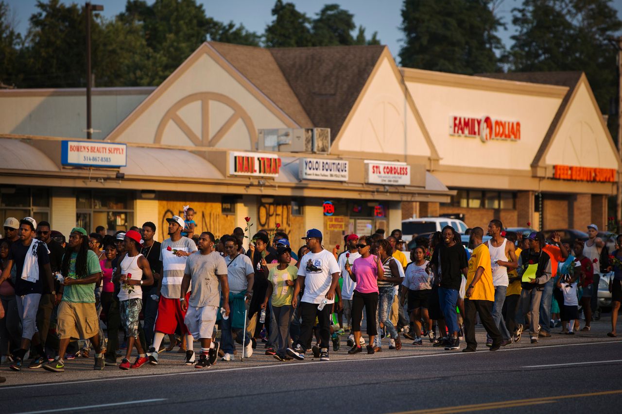 Demonstrators are seen during a peaceful march near Ferguson, Aug. 18, 2014.