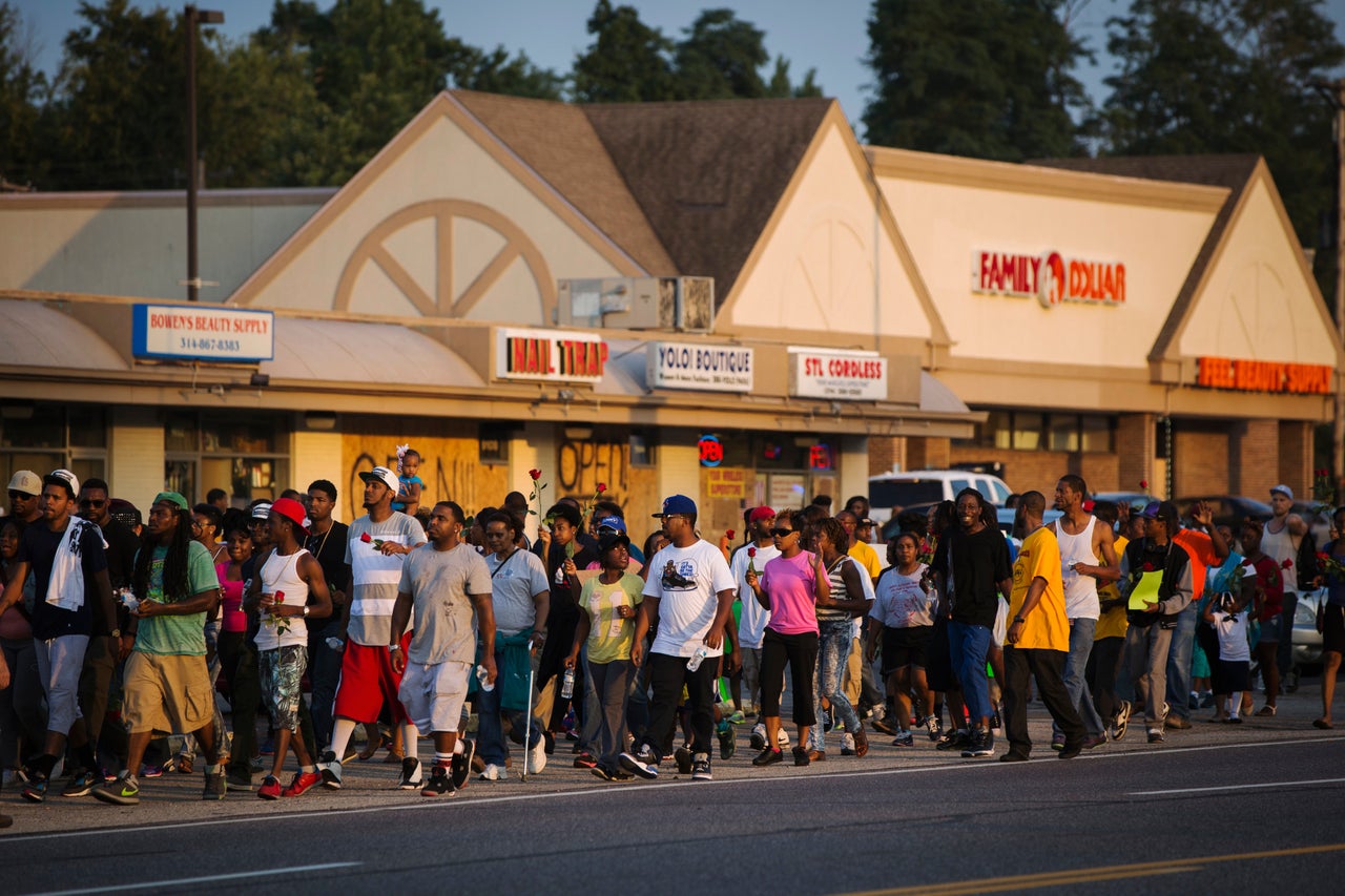 Demonstrators are seen during a peaceful march near Ferguson, Aug. 18, 2014.