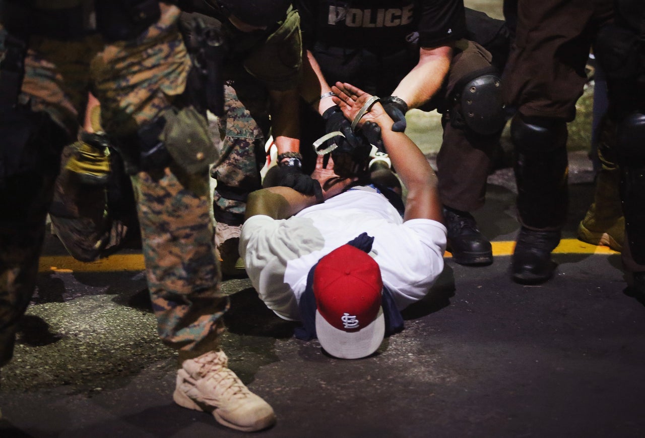 Police arrest a demonstrator in Ferguson on Aug. 19, 2014.