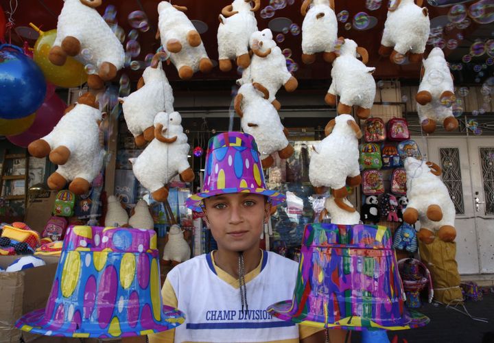 A Palestinian boy shops for accessories in the West Bank city of Hebron on August 31, 2017, on the eve of the Muslim holiday of Eid al-Adha.