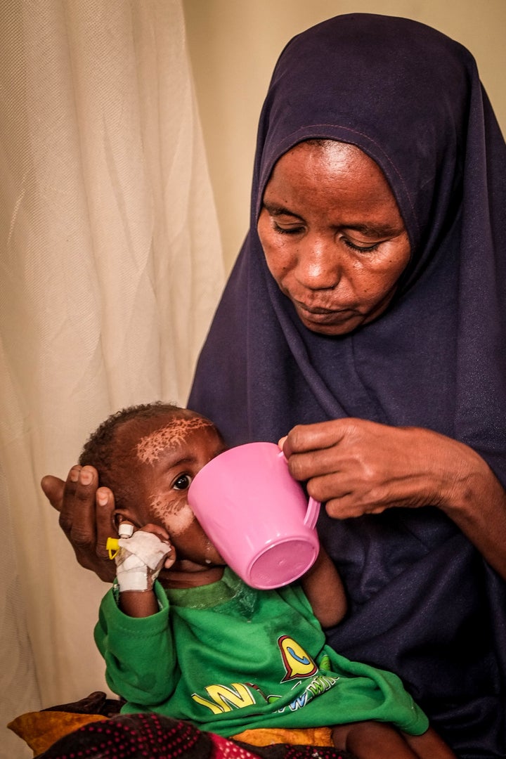 <p>7-month-old Samira being fed by her mother</p>