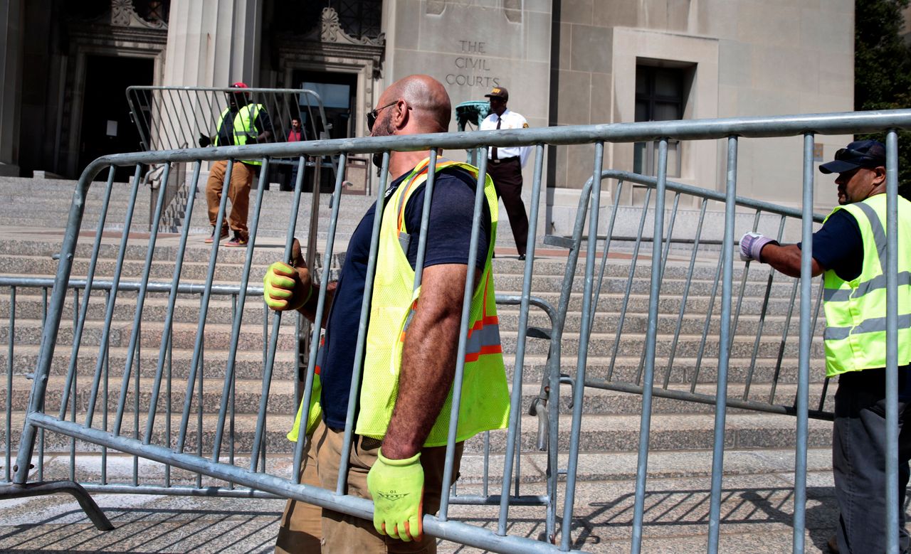 City workers erect barricades around the Civil Courts and Carnahan courthouses on Aug. 29, 2017, in St. Louis.