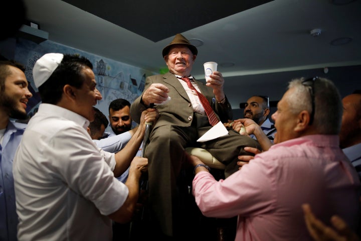 Shalom Shtamberg, a 93-year old Holocaust survivor, is lifted on a chair during celebrations marking his bar mitzvah ceremony, a Jewish coming-of-age celebration traditionally marked by boys at the age of 13, in Haifa, Israel August 31, 2017.