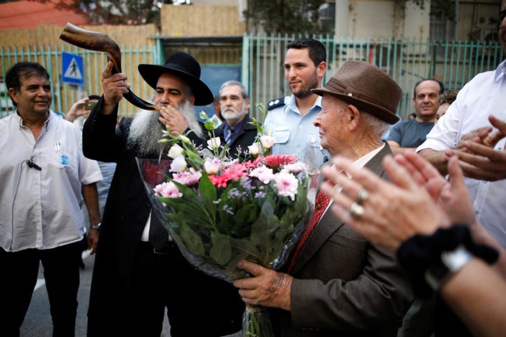 Shtamberg listens as a rabbi blows the Shofar, as part of celebrations marking his bar mitzvah ceremony.