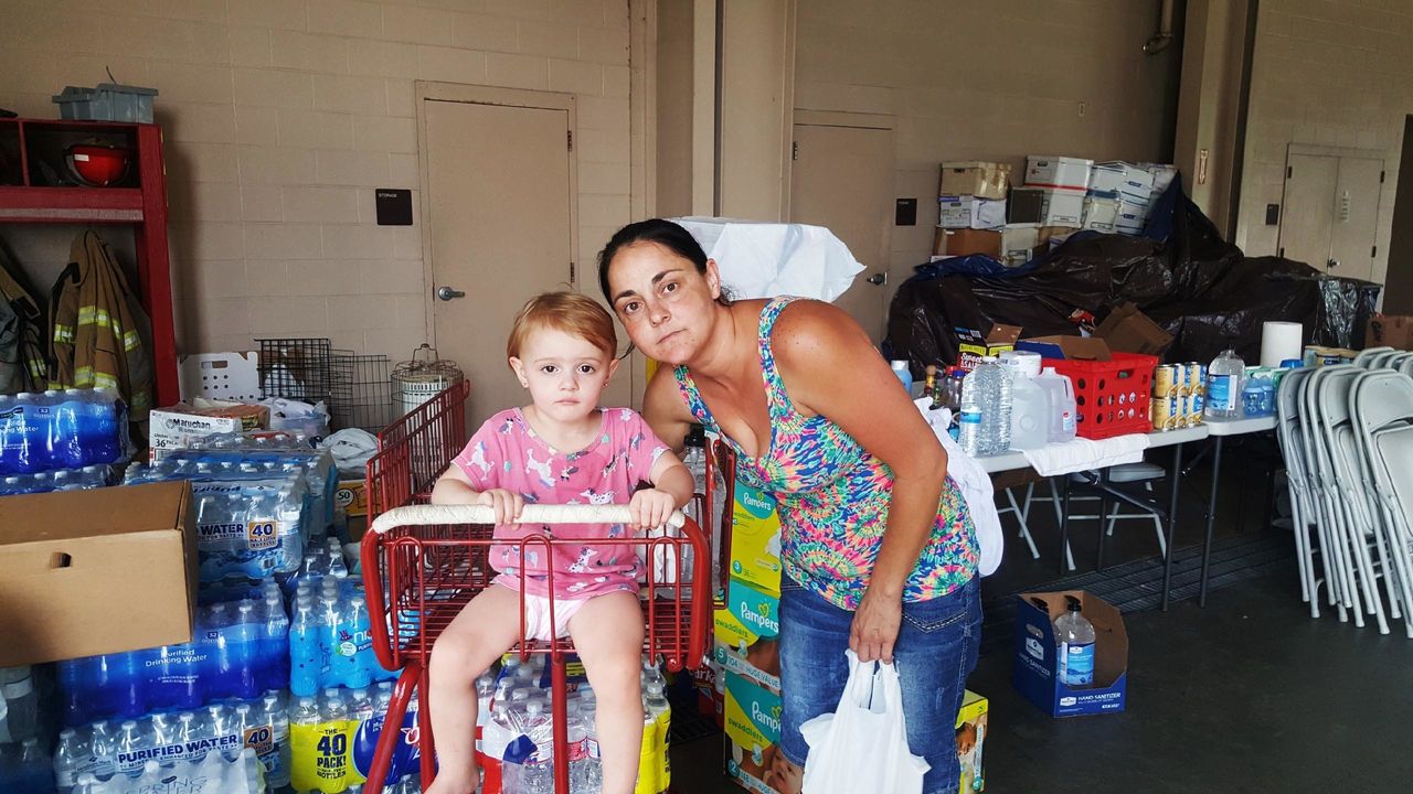 Beth Dougherty and her 2-year-old daughter, Natalee, are staying at the Orange County Emergency Services building in Orange, Texas. Their home was surrounded by floodwaters.