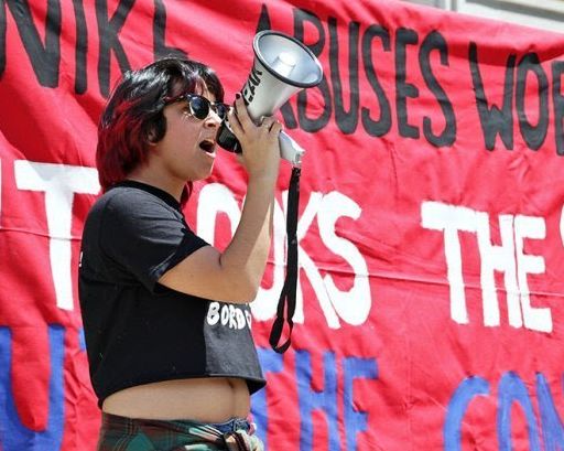 A student activist at UT Austin speaks during a campaign action.
