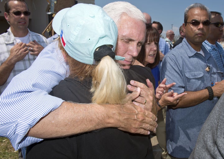 Vice President Mike Pence hugs a woman during a trip to survey the damage from Hurricane Harvey in Rockport, Texas, on Aug. 3