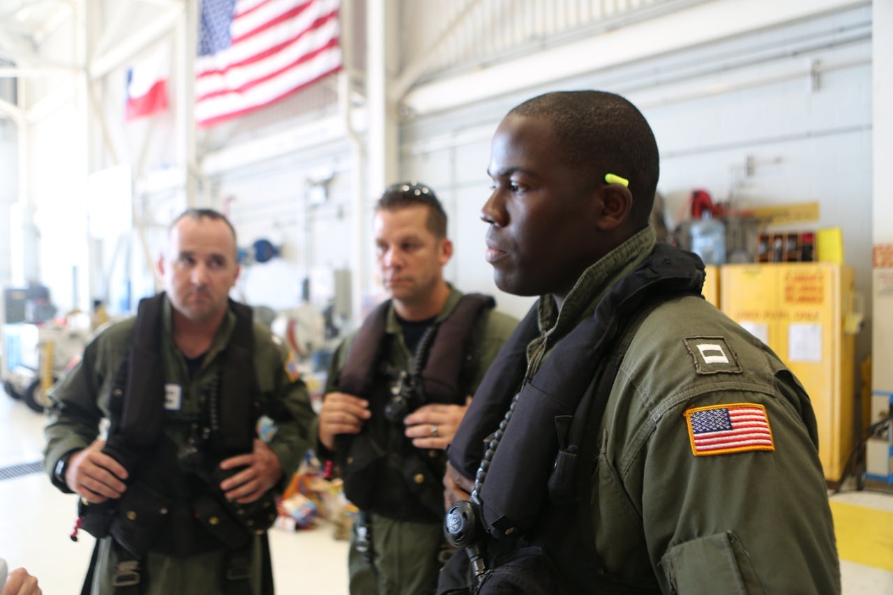 Coast Guard pilot Jason Brownlee, at right, is seen with commander John Egan, left, and flight mechanic Eric Cybulski, center.