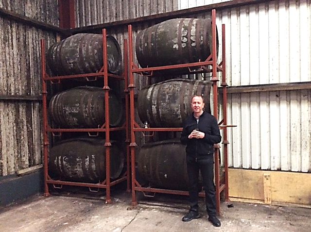 Ally Alpine standing next to six ex-sherry barrels of maturing Celtic Cask whiskey.