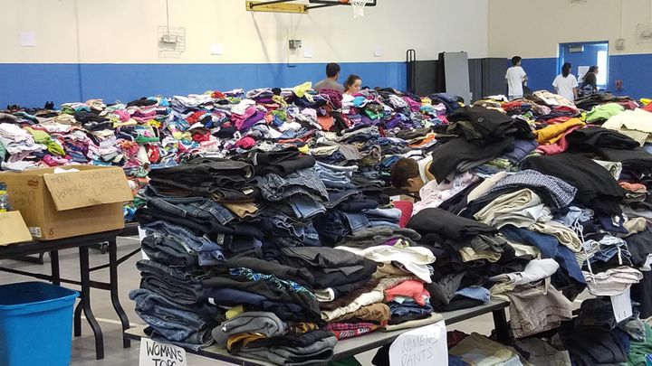 Volunteers at a temporary shelter at St. Theresa’s Catholic Church in Sugar Land, TX, sort through the clothing donations received in the first days after Harvey.