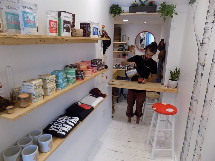 Bryce pours mushroom coffee, one of the Shroom Room’s many healthy products being sampled.