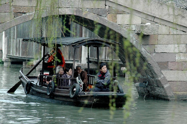 <p> <em>A popular way to experience the magnificent scenery of Wuzhen and its bridges is by boat</em></p>