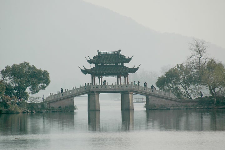  A bridge adds to the picturesque quality of West Lake, Hangzhou, China, as charming as it was in Marco Polo’s day.