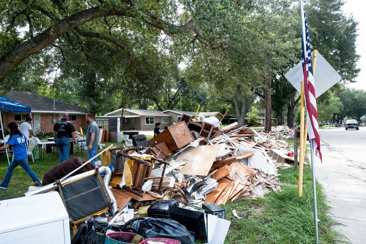 Crews of volunteers help locals in Katy rip out damaged furniture, roofing, flooring and wood from homes.