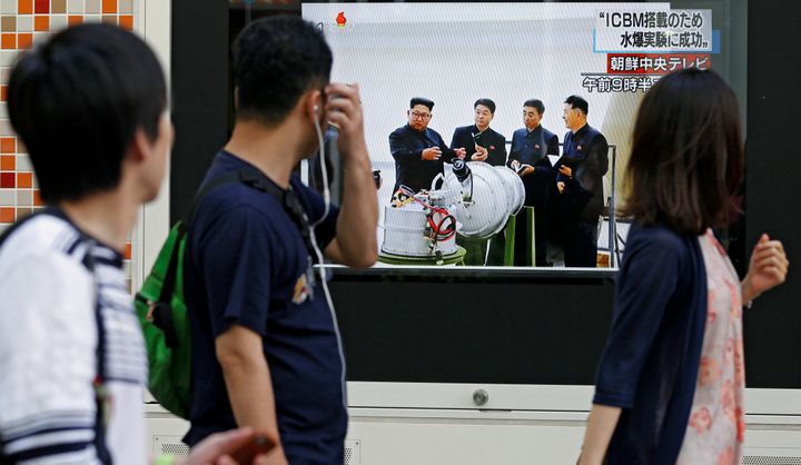 People walk past a street monitor showing North Korea's leader Kim Jong-Un in a news report about North Korea's nuclear test, in Tokyo, Japan, 3 September.