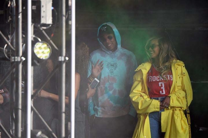 Jay-Z and Beyoncé watch a performance from the stage on Sunday.