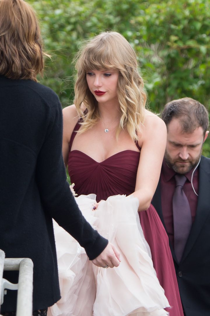 Taylor Swift is seen carrying the back of her BFF Abigail's wedding dress as they arrive at a church in Martha's Vineyard. 