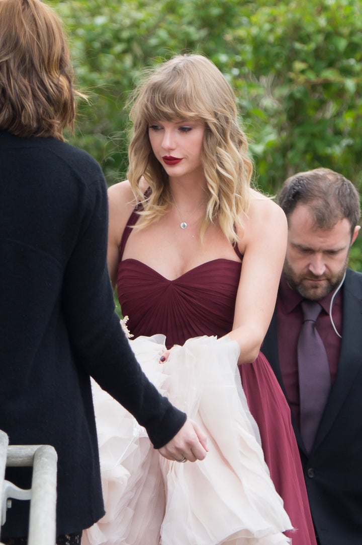 Taylor Swift is seen carrying the back of her BFF Abigail's wedding dress as they arrive at a church in Martha's Vineyard.&nb