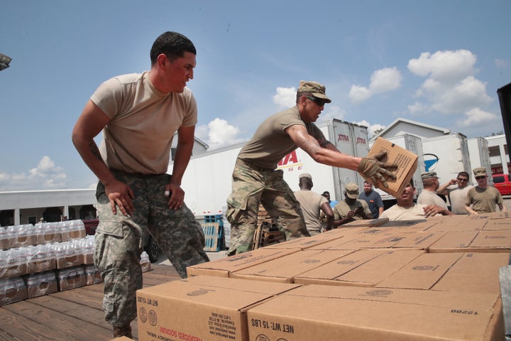 Members of the Texas Army National Guard from El Paso, Texas distribute food and water to flood victims in Orange, Texas,