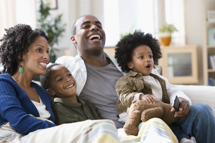 African American family watching television together Blend Images - KidStock via Getty Images