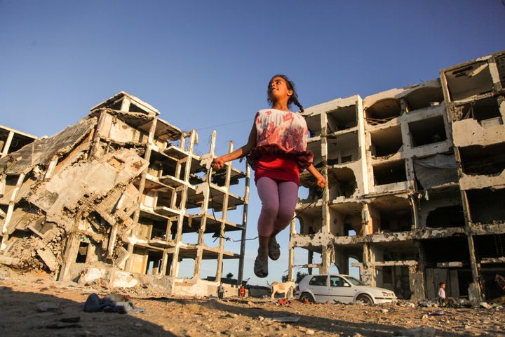 Girl playing in the Gaza rubble 