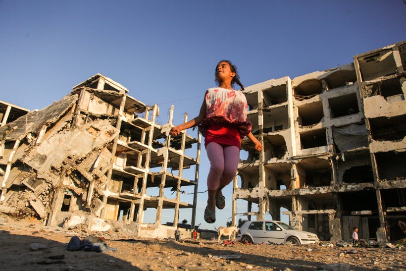 Girl playing in the Gaza rubble