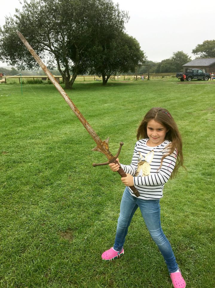 Matilda Jones, from Norton, Doncaster, shows off a mighty sword that she found at the bottom of a lake where King Arthur's said to have returned his Excalibur.