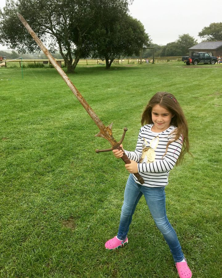 Matilda Jones, from Norton, Doncaster, shows off a mighty sword that she found at the bottom of a lake where King Arthur's said to have returned his Excalibur.