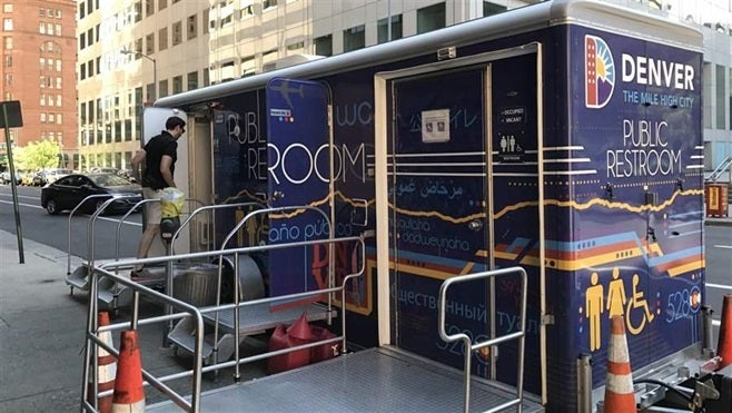 A man enters a mobile restroom in downtown Denver. City officials hope the bathrooms will make the urban core cleaner and more inviting.