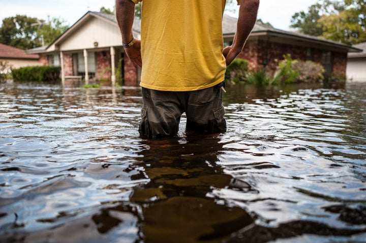 Oden “Odie” Walder walks up to his flooded home in Angleton, Texas, on Monday.