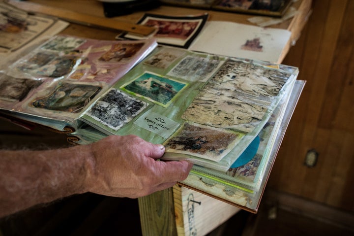 Gary Puett looks through a childhood photo album that was damaged in the flooding from Harvey.