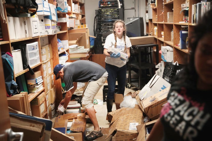 Students help clean up damage at a Houston-area school that was damaged during Tropical Storm Harvey.