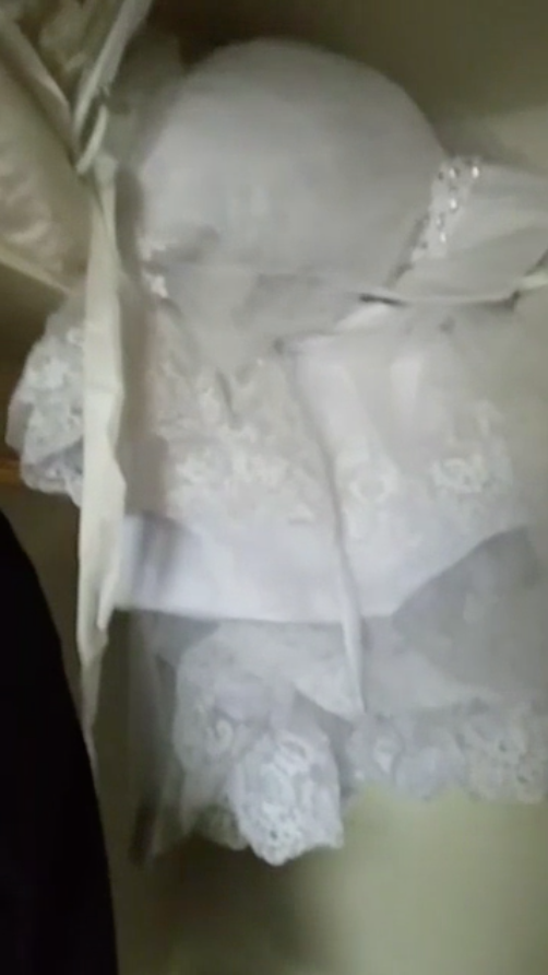 A screenshot from Parry's Facebook Live video, showing the wedding dress still dry inside the closet. 