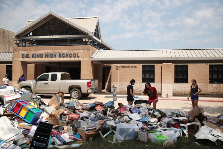 Volunteers and students from Houston's C.E. King High School help clean up the school in the aftermath of Tropical Storm Harvey on Sept. 1, 2017.