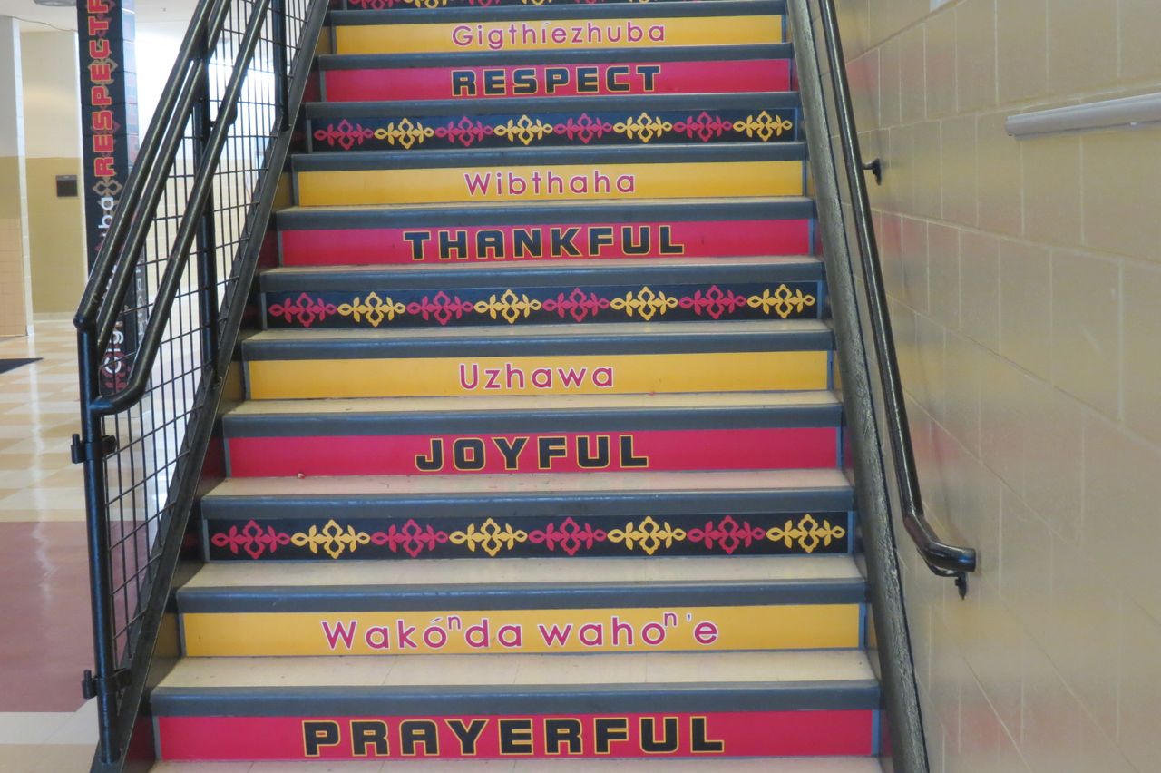 Stairs in Umonhon Nation Public School with words in English and Umonhon.