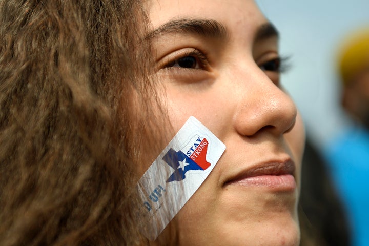 A 10th grader with a 'stay strong' sticker marched with students, immigrants and impacted individuals to Tivoli Quad on Denve