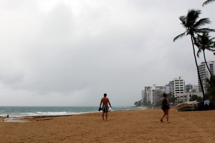 A couple walks on a beach as hurricane Irma approaches Puerto Rico in San Juan, on Sept. 5.
