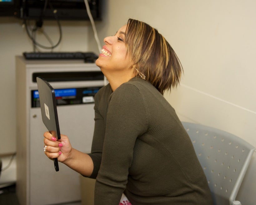 Cancer patient’s mom is treated to a hair cut and make-up while her child receives treatment.