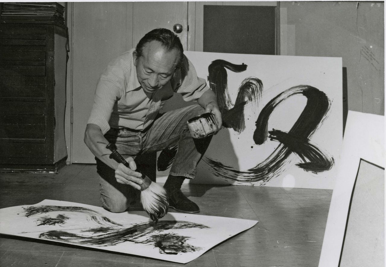 Tyrus Wong painting in his studio.