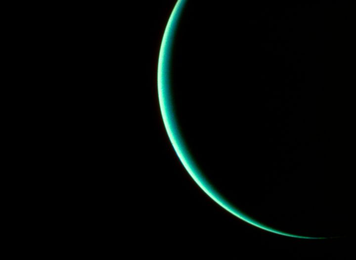 The planet Uranus, obscured except for a thin crescent, photographed by interplanetary probe Voyager 2 on January 25, 1986.