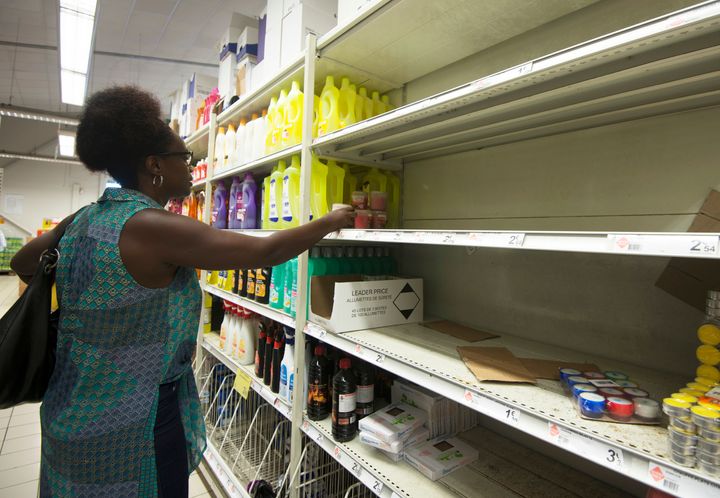 A woman buys candles at a supermarket in Pointe-a-Pitre, on the French overseas island of Guadeloupe
