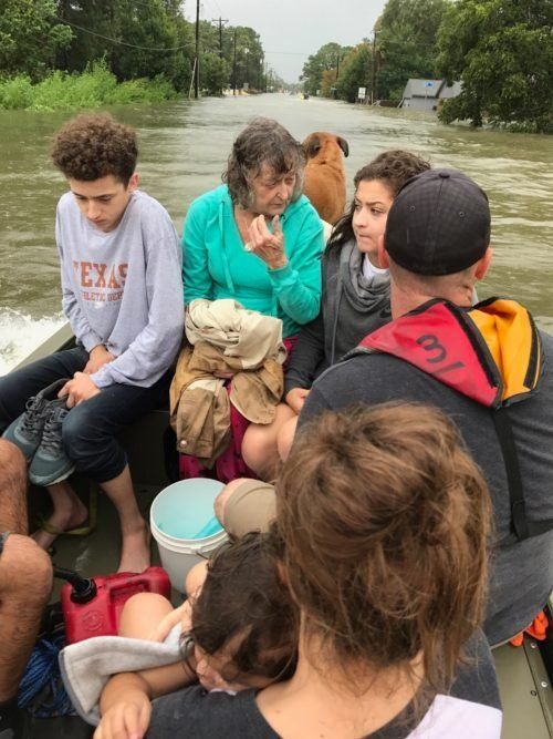 Tim Miller's granddaughter Natalie (front right), with other members of her family and Odie Walder, boating to safety in the aftermath of Harvey.