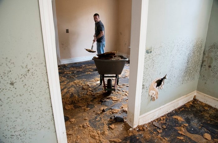 <p>Brent Davis helps clean out a home damaged by floodwaters from Hurricane Matthew in Nichols, South Carolina, in October 2016. </p>