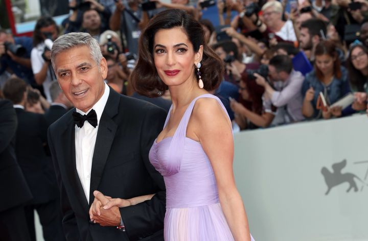George and Amal Clooney walk the red carpet before a screening of "Suburbicon" during the 74th Venice Film Festival.