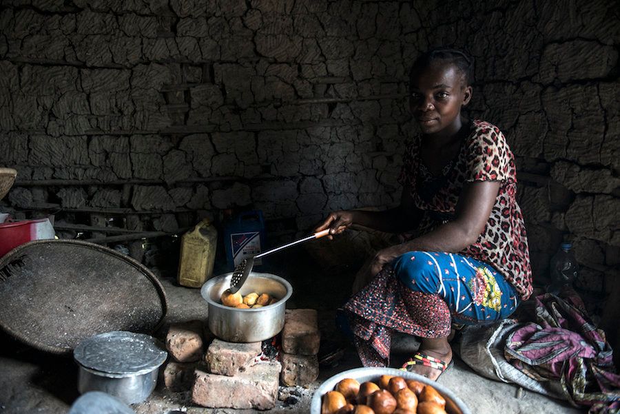 A mother whose sons contracted sleeping sickness in the village of Isangi makes doughnuts in her kitchen.