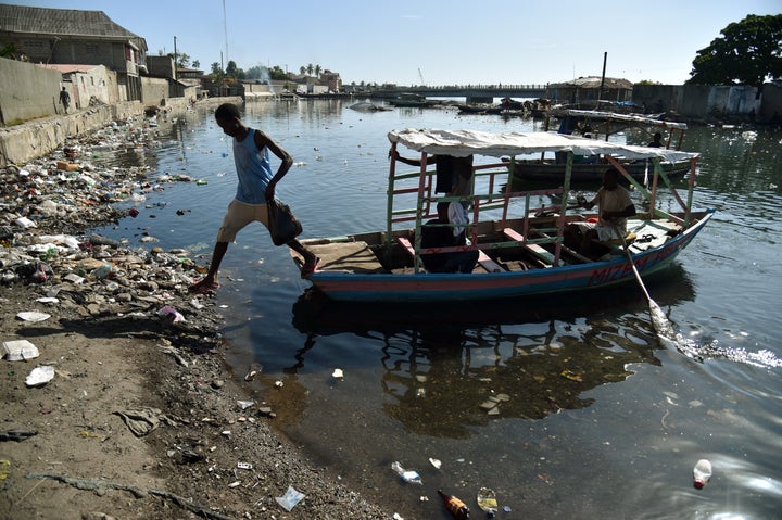 A man jump fron a boat in Mapou River in Cap-Haitien, Haiti, on September 6, 2017. Inhabitants of Shada, a poor riverside com