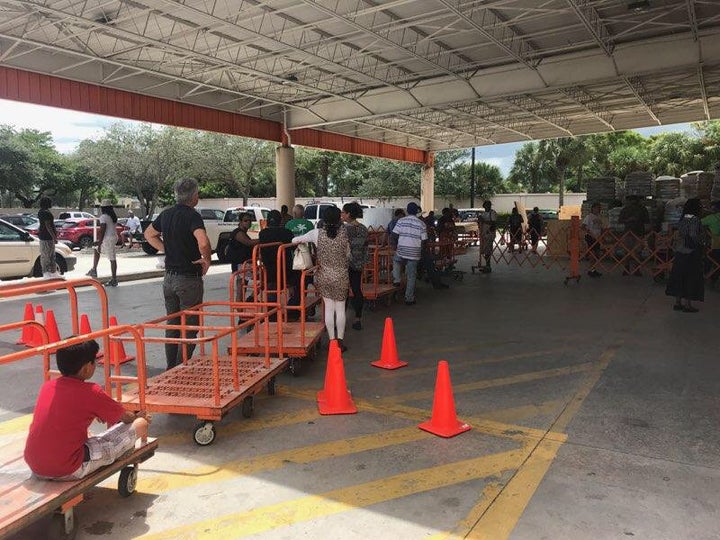 Fort Lauderdale-area residents line up for sheets of plywood at a Home Depot as they prepare for the arrival of Hurricane Irma on Wednesday.