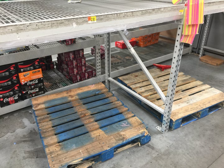 Wooden pallets and shelves that used to hold stacks of bottled water are empty at a Walmart in Fort Lauderdale on Wednesday.