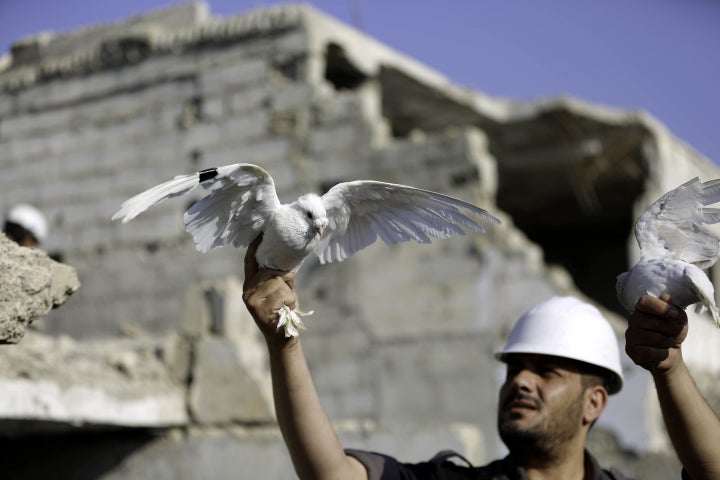 A member of the White Helmets let a white pigeon fly for people who lost his life in a chemical attack in the Eastern Ghouta region of Damascus, Syria on August 22.